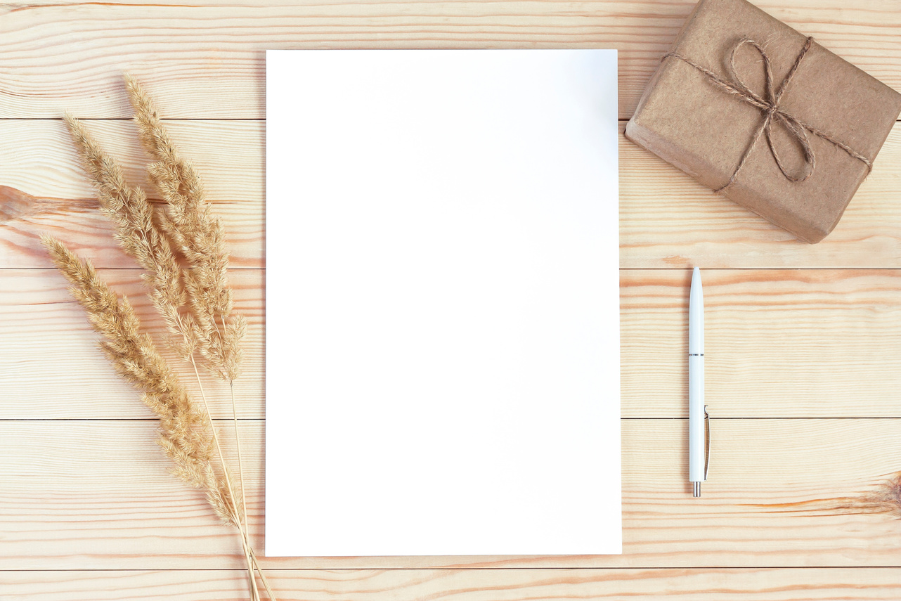 Blank sheet of paper mockup on wooden table